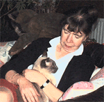 Siamese cat Spock having a cuddle with Ann
